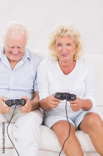 Photo: Old couple playing video games Old couple playing video games
