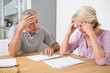 Photo: Focused couple reading documents together Focused couple reading documents together