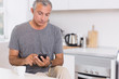 Photo: Focused man touching his smartphone Focused man touching his smartphone