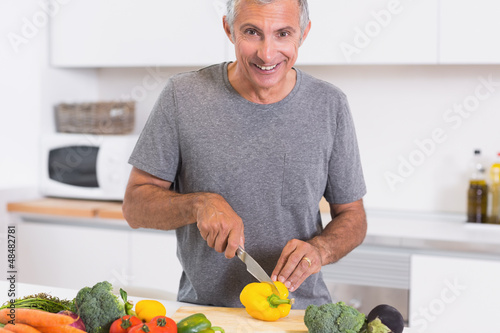 Photo: Man cutting a yellow pepper Man cutting a yellow pepper