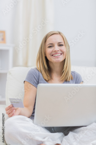 Photo: Portrait of casual woman doing online shopping at home Portrait of casual woman doing online shopping at home
