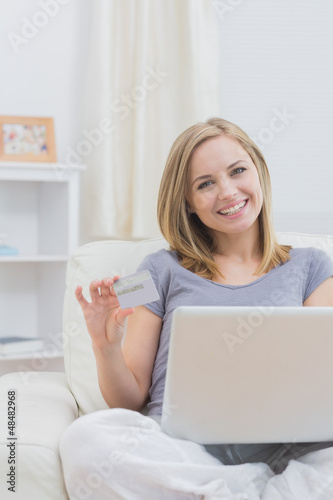 Photo: Portrait of casual woman doing online shopping at home Portrait of casual woman doing online shopping at home