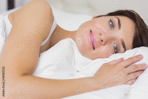 Photo: Female smiling in bed Female smiling in bed