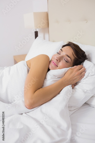 Photo: Woman sleeping comfortably in bed Woman sleeping comfortably in bed
