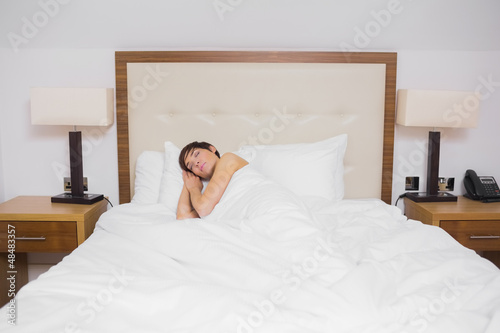 Photo: Brunette woman sleeping in bed Brunette woman sleeping in bed