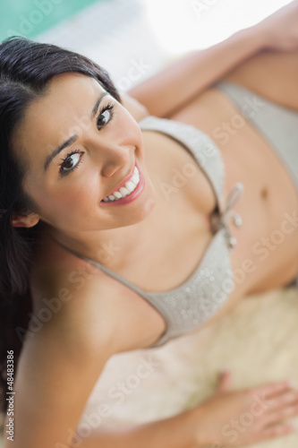Photo: Happy woman relaxing by pool Happy woman relaxing by pool