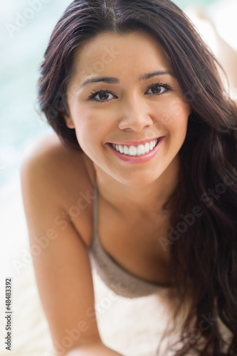 Photo: Smiling girl lying by the pool Smiling girl lying by the pool