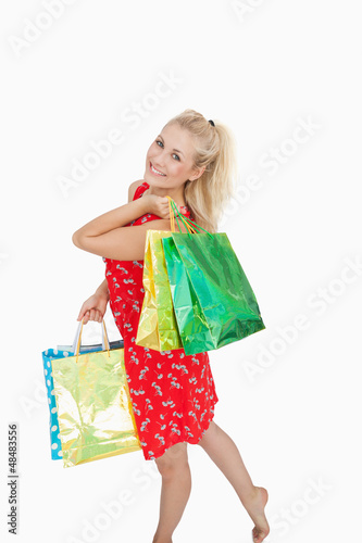 Photo: Portrait of cute young woman with shopping bags Portrait of cute young woman with shopping bags