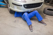 Mechanic working under car