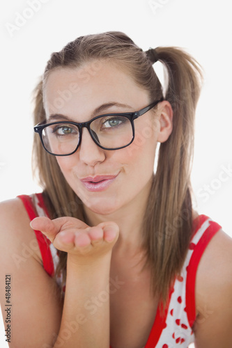 Photo: Portrait of young woman blowing air kiss Portrait of young woman blowing air kiss