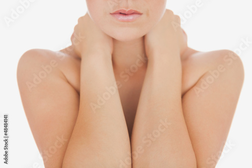 Photo: Woman massaging neck over white Woman massaging neck over white