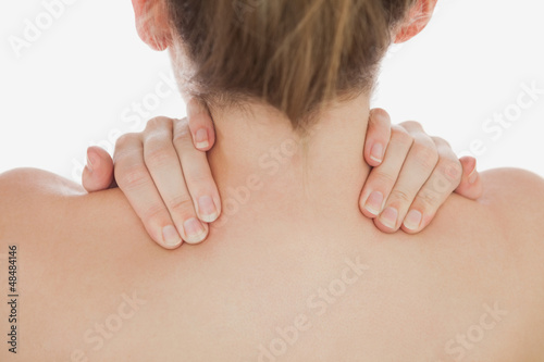 Photo: Close-up of of woman massaging neck Close-up of of woman massaging neck