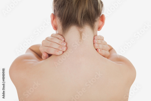 Photo: Topless woman massaging her neck Topless woman massaging her neck