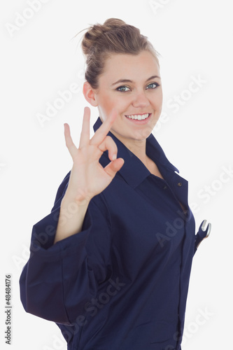 Photo: Female mechanic showing ok sign Female mechanic showing ok sign