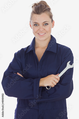 Photo: Beautiful female mechanic holding wrench Beautiful female mechanic holding wrench