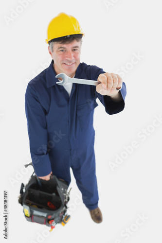 Photo: Technician with wrench carrying tool bag Technician with wrench carrying tool bag