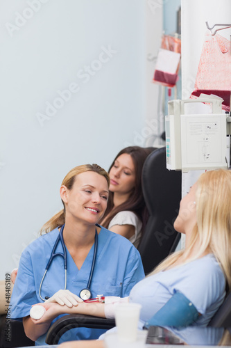 Photo: Nurse smiling to a blood donor Nurse smiling to a blood donor
