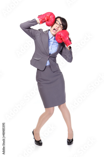 Photo: business woman boxing and knock down itself business woman boxing and knock down itself