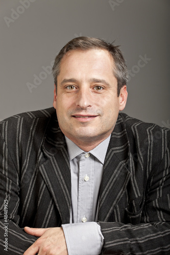 Photo: portrait of adult man isolated on dark background portrait of adult man isolated on dark background