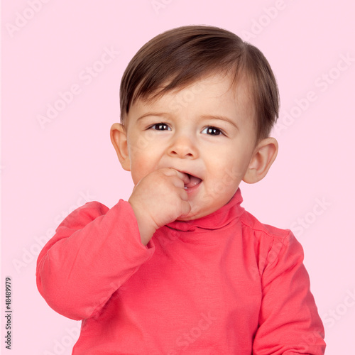 Photo: Adorable baby girl with her hand in mouth Adorable baby girl with her hand in mouth