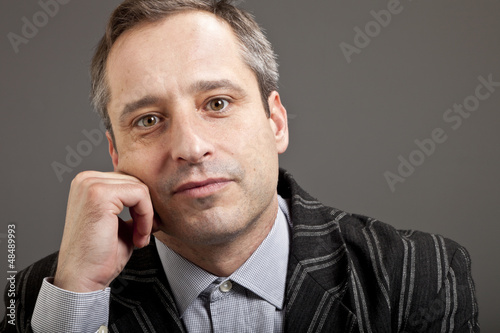 Photo: portrait of adult man isolated on dark background portrait of adult man isolated on dark background