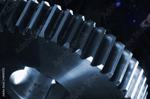 Photo: large gear wheel in space, planets and stars, sci-fi concept large gear wheel in space, planets and stars, sci-fi concept