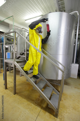 Photo: technician examining sample - industrial process control technician examining sample - industrial process control