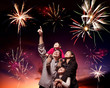 happy family looking fireworks in the evening sky