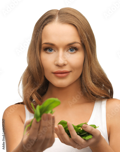 Photo: woman with spinach leaves on palms woman with spinach leaves on palms