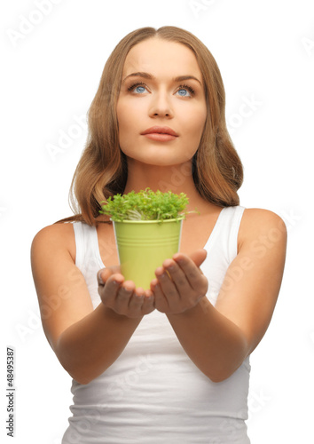 Photo: woman with green grass in pot woman with green grass in pot