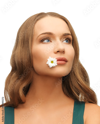 Photo: woman with camomile in mouth woman with camomile in mouth