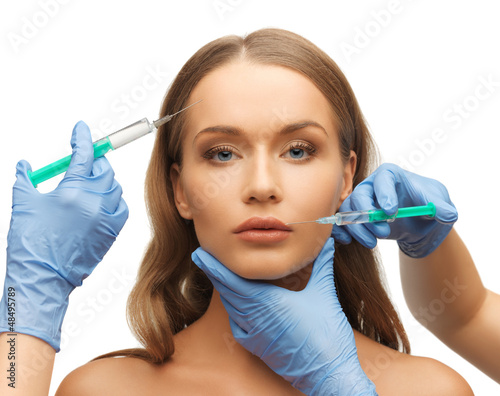 Photo: woman face and beautician hands woman face and beautician hands