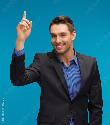 Photo: man in suit with his finger up man in suit with his finger up