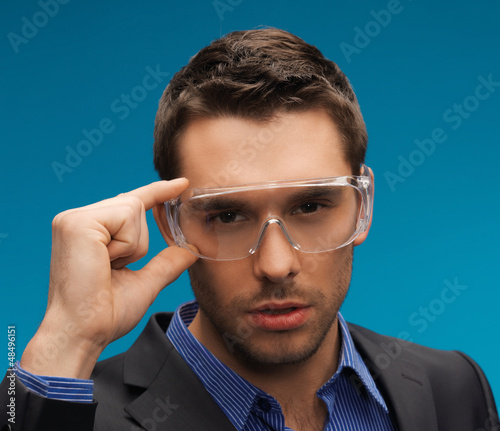 Photo: businessman in protective glasses businessman in protective glasses
