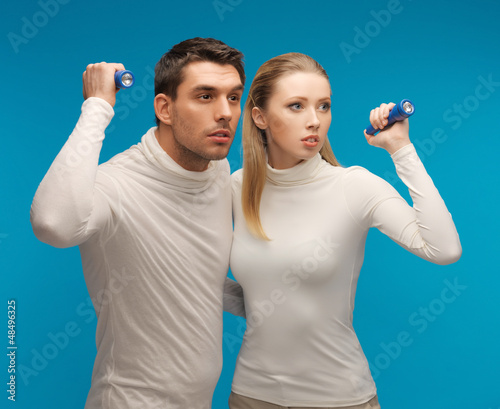Photo: man and woman with pocket flashlights man and woman with pocket flashlights