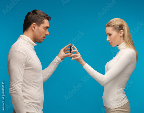 Photo: man and woman with modern gadgets man and woman with modern gadgets