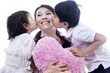 Photo: Happy mother kissed by children - isolated Happy mother kissed by children - isolated