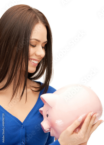 Photo: lovely woman with piggy bank lovely woman with piggy bank