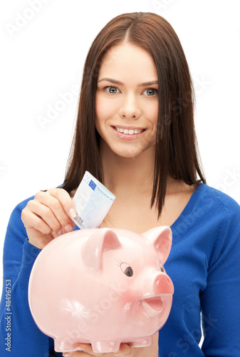 Photo: lovely woman with piggy bank and money lovely woman with piggy bank and money