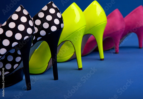 Photo: Colorful high heels on blue background Colorful high heels on blue background