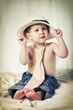 Portrait of the little boy with tie and hat