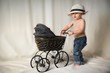 Portrait of a boy with a stroller in the studio