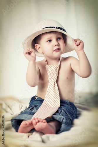 Photo: Portrait of the little boy with tie and hat Portrait of the little boy with tie and hat