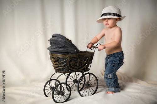 Photo: Portrait of a boy with a stroller in the studio Portrait of a boy with a stroller in the studio