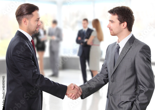 Photo: business people shaking hands over a deal business people shaking hands over a deal