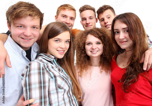 Photo: Casual group of excited friends isolated on white Casual group of excited friends isolated on white