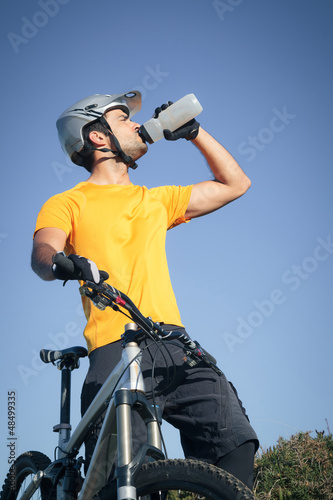 Photo: Mountain biker drinking water Mountain biker drinking water