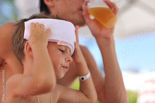 Photo: In the summer hot afternoon the father with the son have a rest In the summer hot afternoon the father with the son have a rest