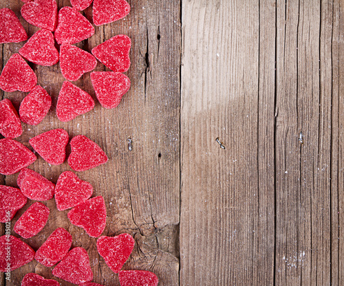 Photo: heart shape candy on wooden plank heart shape candy on wooden plank