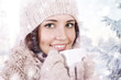 Winter girl drinking warm beverage.